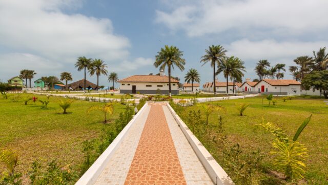 Beautiful pavement and the houses surrounded by grassy fields captured in Gambia, Africa